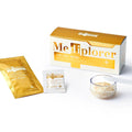 Me Tiplorer product set including boxes, packets, and a glass with powder on a white background