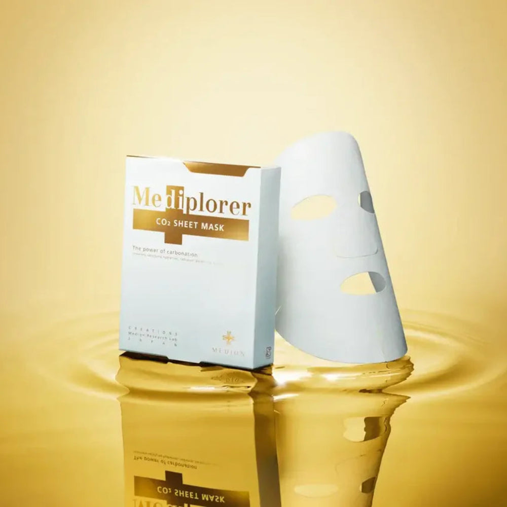 MeTiplorer CO2 sheet mask packaging on a reflective gold surface