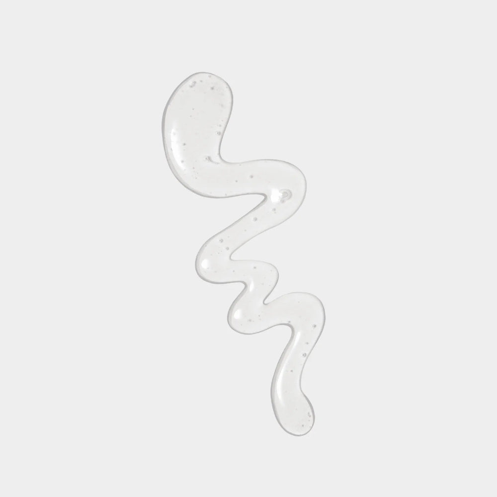 Transparent gel-like substance in a wavy pattern on a light gray background