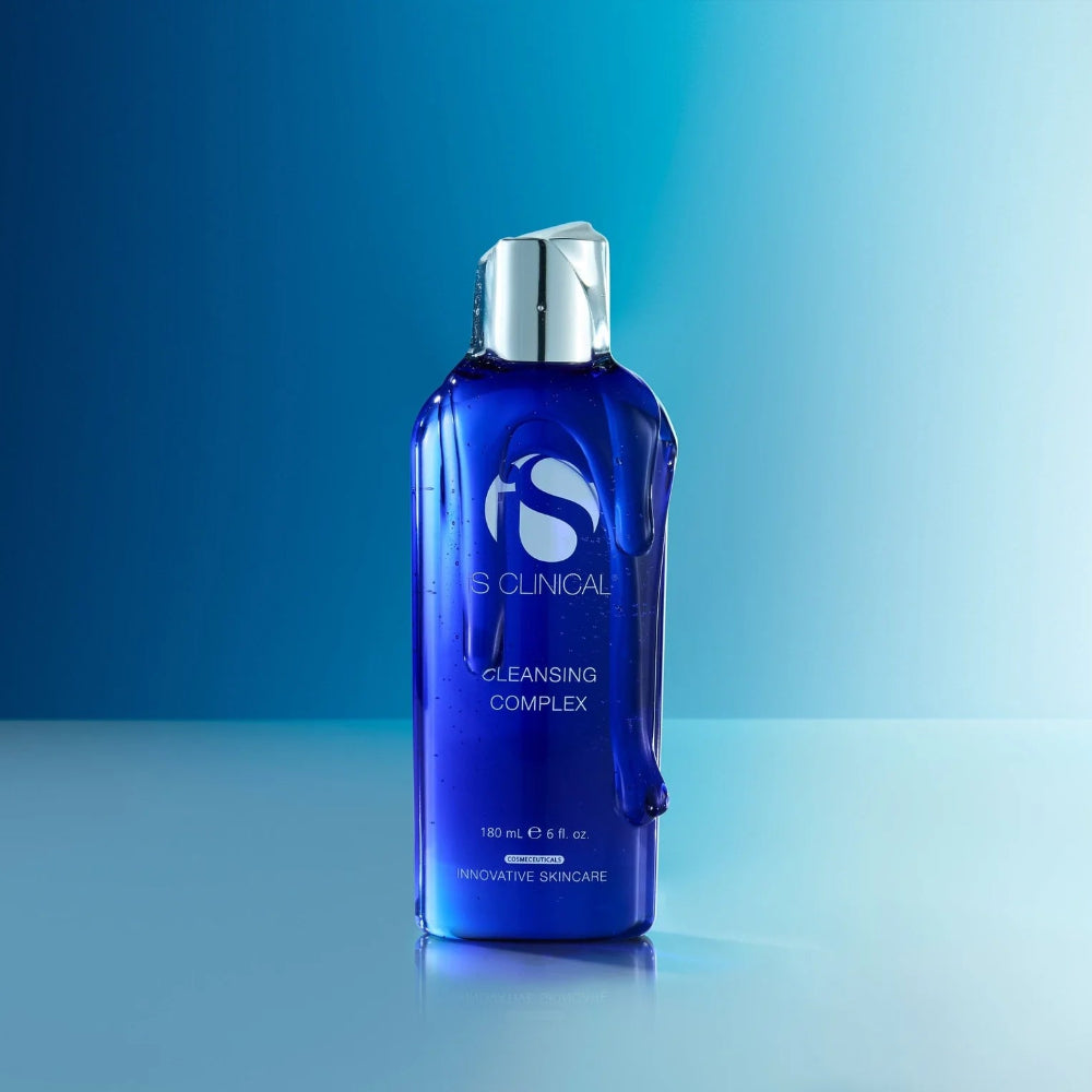 Blue bottle of skincare product with silver cap on a gradient blue background