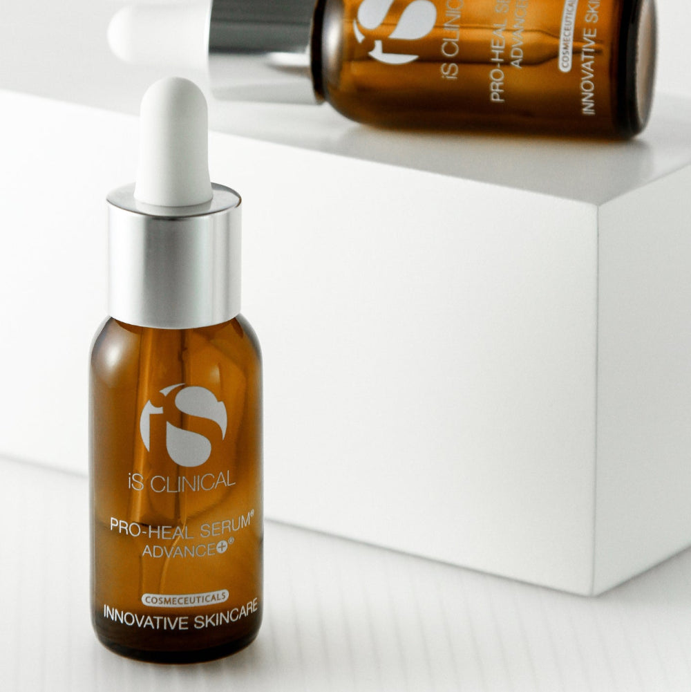Two bottles of IS Clinical skincare serum on a white background