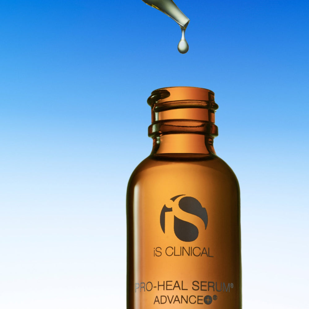 IS Clinical Pro-Heal Serum Advance bottle with dropper on a blue gradient background