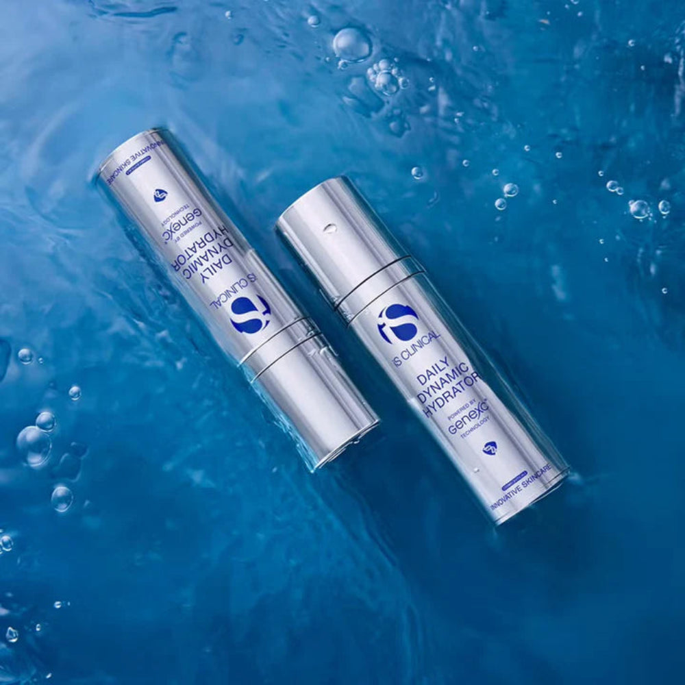 Two skincare bottles on a blue water background