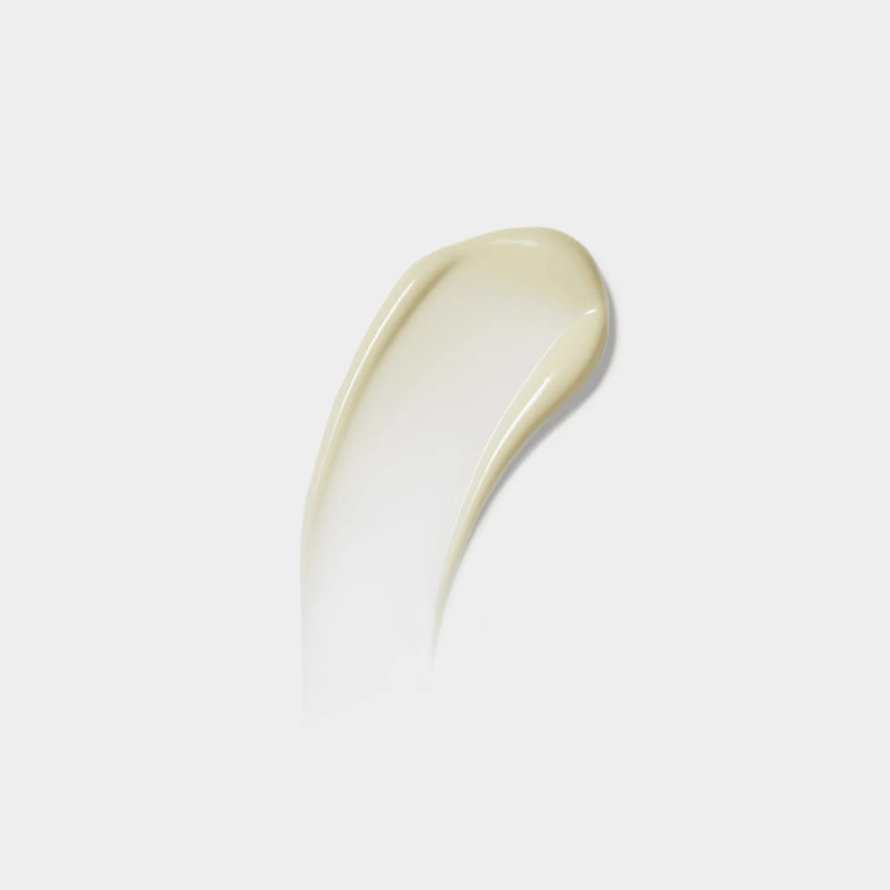 White cream smear on a light gray background