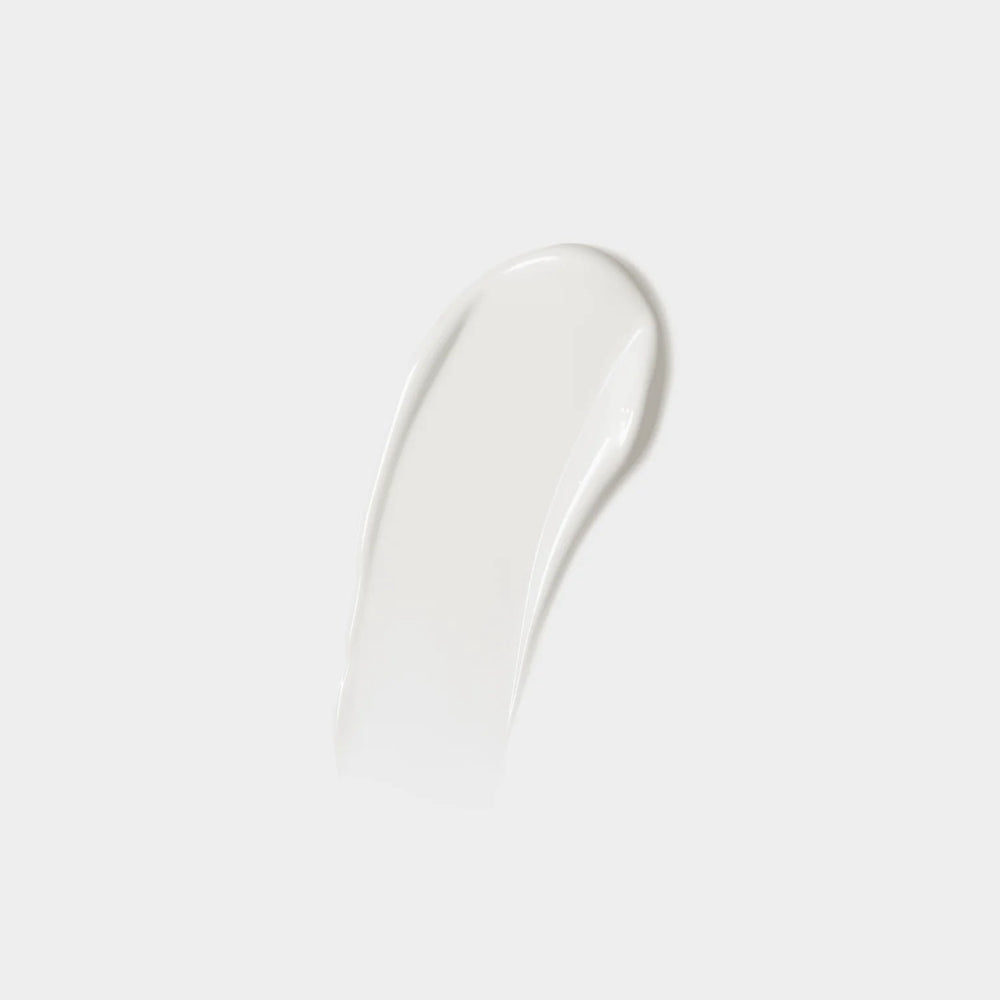 White cream smear on a light gray background
