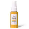Sunscreen spray bottle with yellow body and white cap on a white background